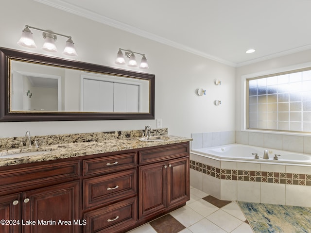 bathroom featuring crown molding, tile patterned floors, vanity, and tiled tub