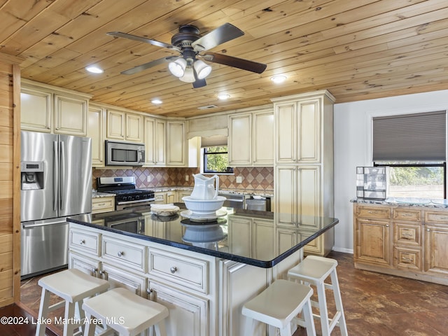 kitchen with a breakfast bar area, tasteful backsplash, wooden ceiling, a kitchen island, and stainless steel appliances