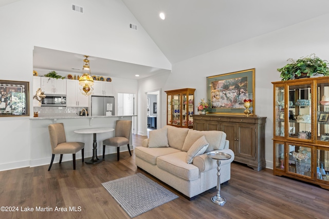 living room featuring dark hardwood / wood-style flooring and high vaulted ceiling