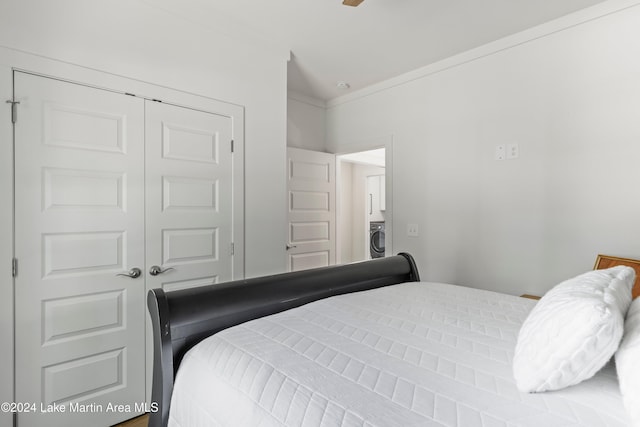 bedroom with washer / clothes dryer and a closet