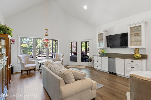 living room with french doors, dark hardwood / wood-style floors, high vaulted ceiling, and plenty of natural light