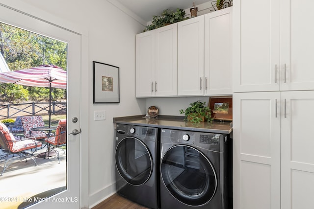 laundry room featuring washer and clothes dryer, dark hardwood / wood-style flooring, cabinets, and crown molding