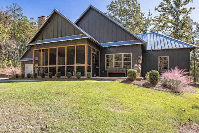 rear view of property with a lawn and a garage