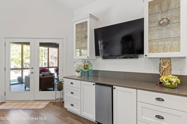 kitchen featuring dark hardwood / wood-style floors, white cabinetry, and french doors