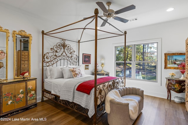 bedroom with ceiling fan, wood-type flooring, and crown molding