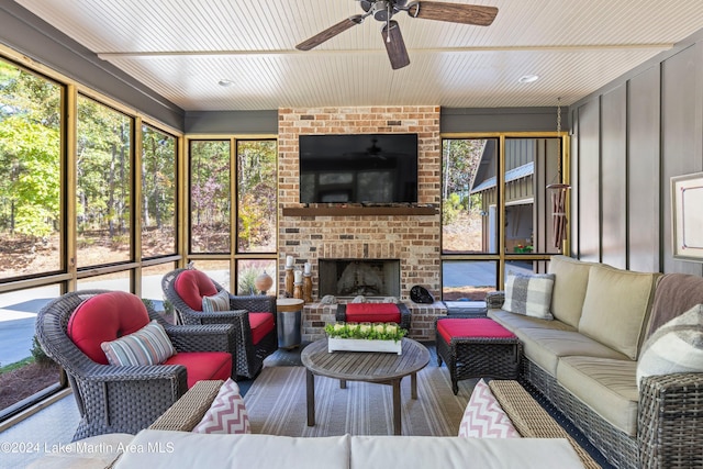 living room with ceiling fan and a brick fireplace