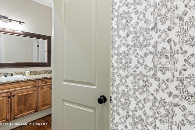 bathroom with vanity and hardwood / wood-style flooring