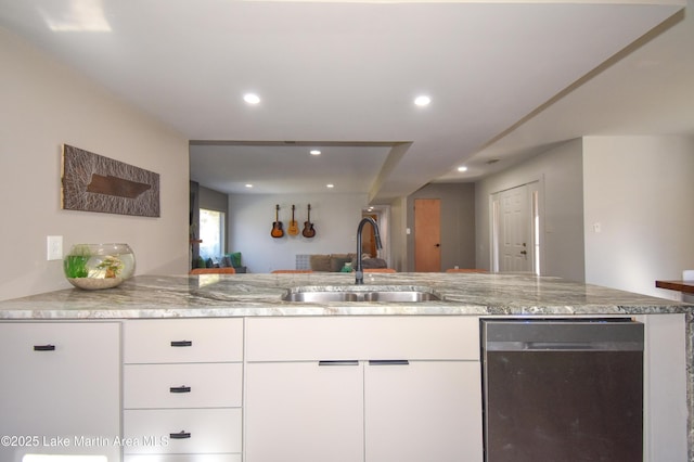 kitchen featuring light stone counters, white cabinetry, recessed lighting, a sink, and stainless steel dishwasher