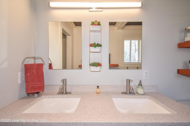 bathroom with a sink and double vanity
