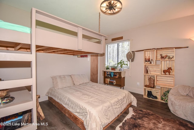 bedroom with baseboards and wood finished floors