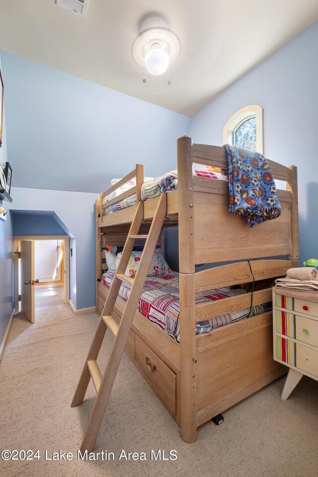 carpeted bedroom featuring vaulted ceiling