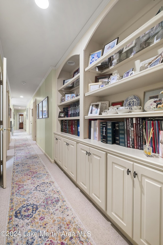 hallway with light carpet and ornamental molding