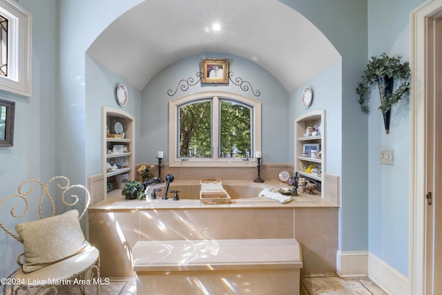 bathroom featuring tiled tub and built in features