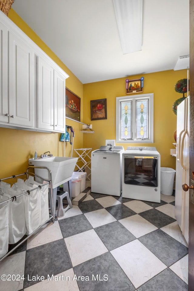 laundry area featuring washer and dryer and cabinets