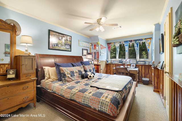 bedroom with light colored carpet, ceiling fan, crown molding, and wood walls