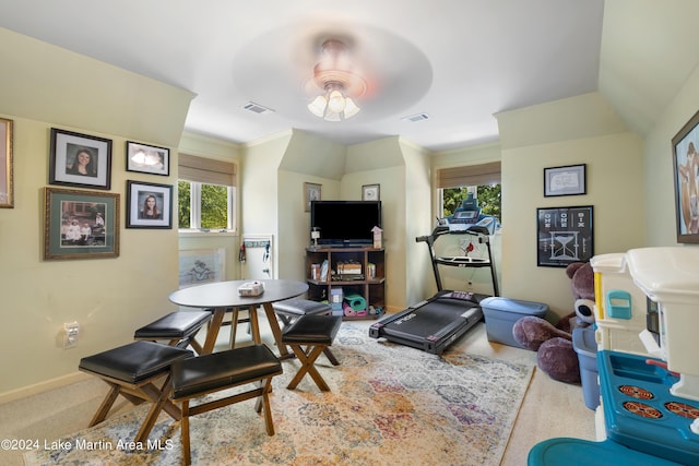 exercise room featuring carpet flooring, a wealth of natural light, ornamental molding, and ceiling fan