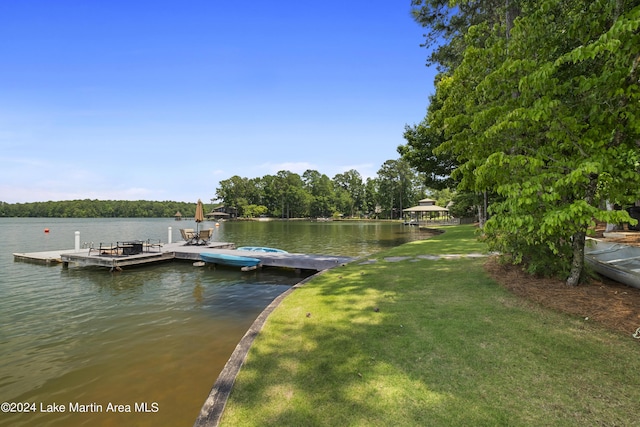 view of dock featuring a yard and a water view