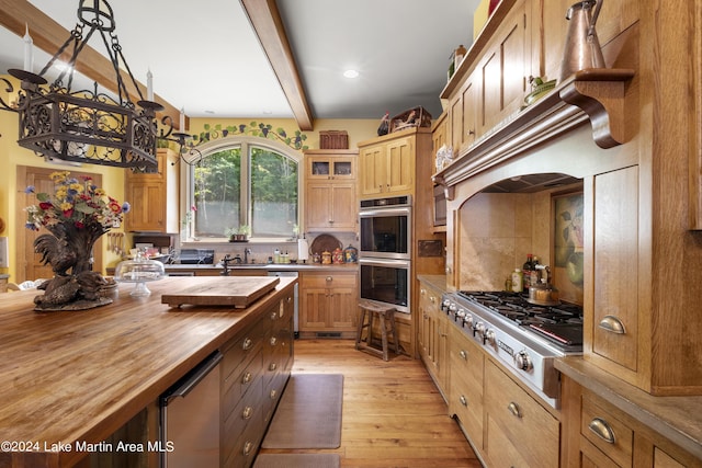 kitchen with light hardwood / wood-style flooring, beamed ceiling, wooden counters, backsplash, and appliances with stainless steel finishes