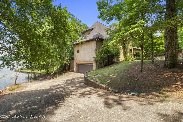 view of front of house with a water view and a garage