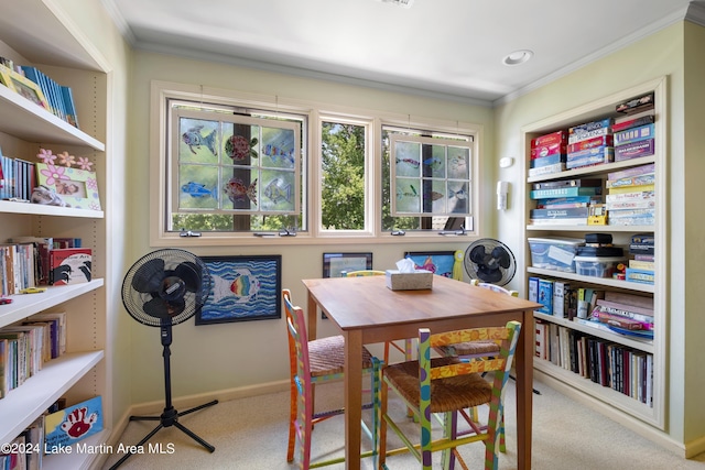 dining space with light colored carpet and ornamental molding