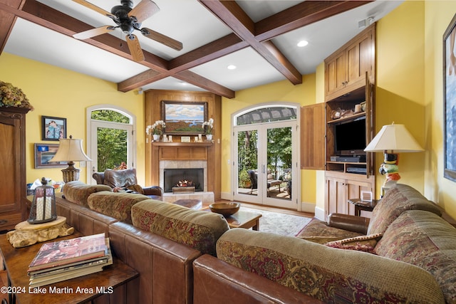 living room with beamed ceiling, french doors, a wealth of natural light, and coffered ceiling