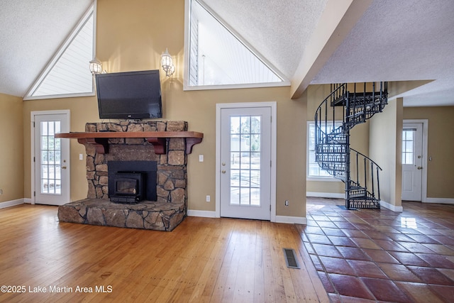 interior space featuring stairs, a textured ceiling, visible vents, and a healthy amount of sunlight