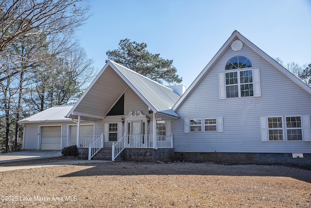 1676 Scott Rd, Alexander City, AL 35010 - view of front of property with a garage, a porch, driveway, and metal roof