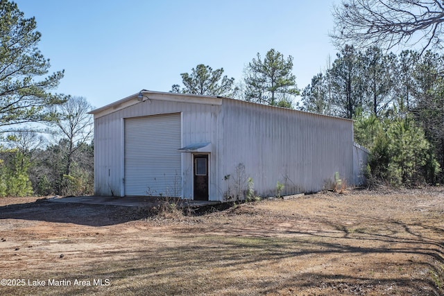 view of outbuilding with driveway and an outdoor structure