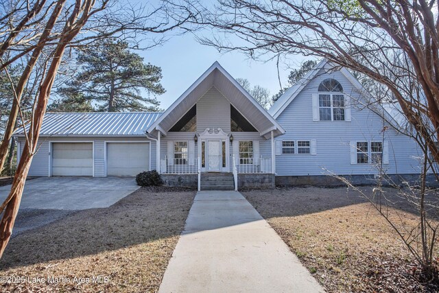 1676 Scott Rd, Alexander City, AL 35010 - view of front of home with concrete driveway, covered porch, an attached garage, and metal roof