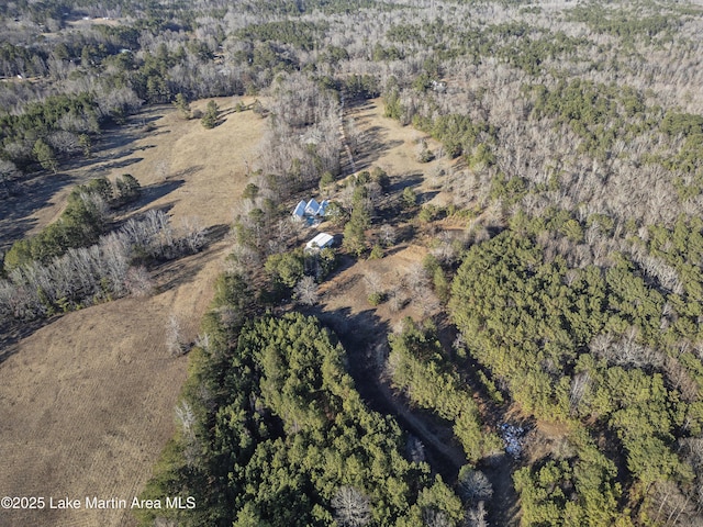 birds eye view of property featuring a view of trees