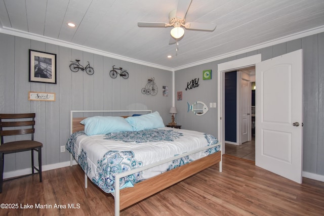 bedroom with wood-type flooring, ornamental molding, and ceiling fan