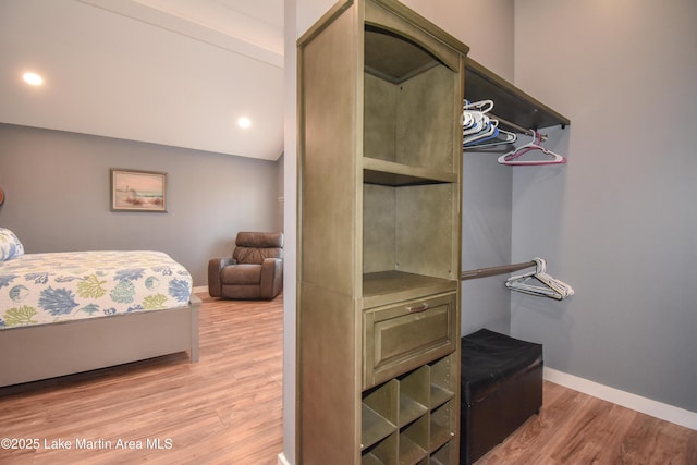 bedroom featuring vaulted ceiling and light wood-type flooring