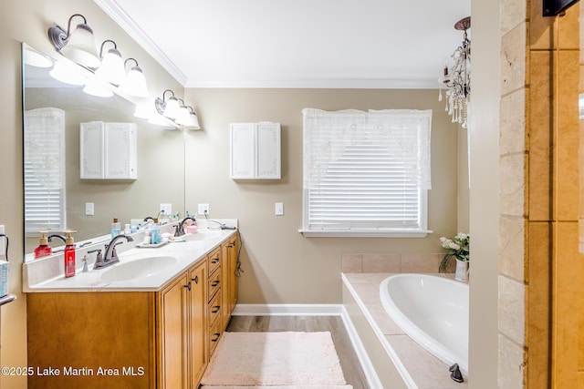 full bathroom with double vanity, a garden tub, ornamental molding, and a sink