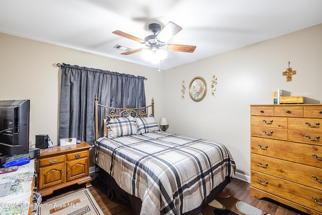 bedroom featuring visible vents, ceiling fan, and dark wood-type flooring