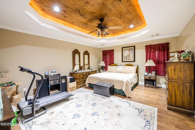 bedroom with wooden ceiling, a tray ceiling, crown molding, visible vents, and wood finished floors
