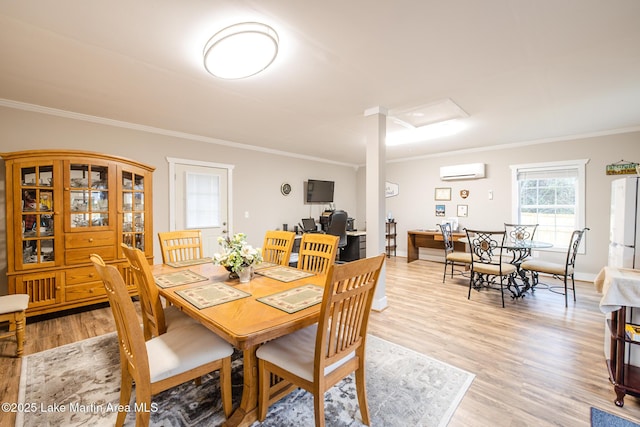 dining area with baseboards, a wall mounted air conditioner, light wood finished floors, and crown molding