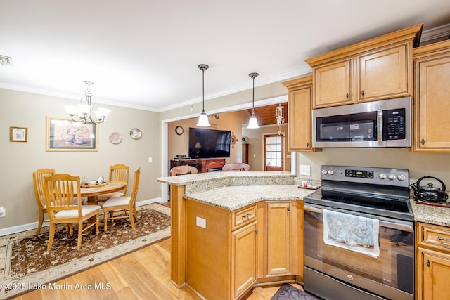 kitchen with appliances with stainless steel finishes, baseboards, light wood finished floors, ornamental molding, and a notable chandelier