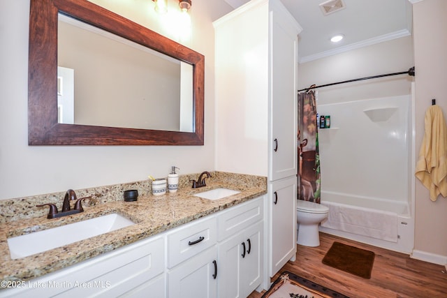 4869 County Road 2225, Troy, AL 36079 - full bath with crown molding, toilet, wood finished floors, double vanity, and shower / bath combo with shower curtain