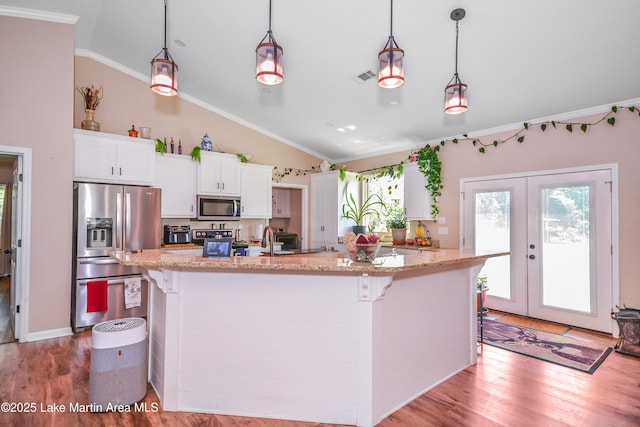 4869 County Road 2225, Troy, AL 36079 - kitchen featuring stainless steel appliances, lofted ceiling, healthy amount of natural light, light wood finished floors, and crown molding