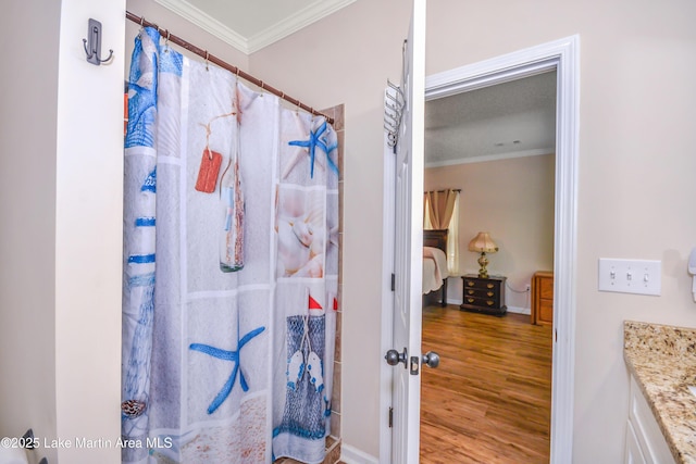 4869 County Road 2225, Troy, AL 36079 - ensuite bathroom featuring ornamental molding, wood finished floors, a shower with shower curtain, baseboards, and vanity