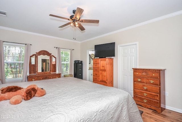 4869 County Road 2225, Troy, AL 36079 - bedroom featuring crown molding, light wood-style floors, baseboards, and ceiling fan