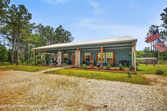 4869 County Road 2225, Troy, AL 36079 - back of house with board and batten siding, metal roof, and fence
