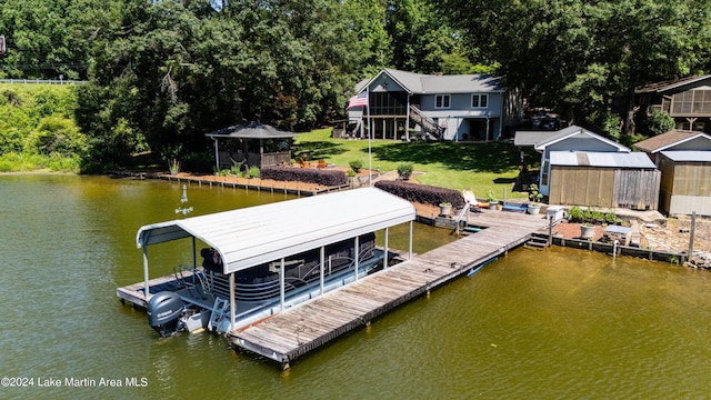 dock area featuring a lawn and a water view