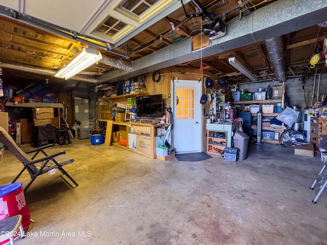 garage featuring heating unit and a garage door opener