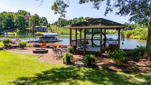 dock area featuring a yard, a water view, and an outdoor fire pit