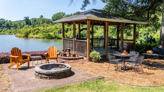 view of patio / terrace featuring a gazebo, a water view, and a fire pit