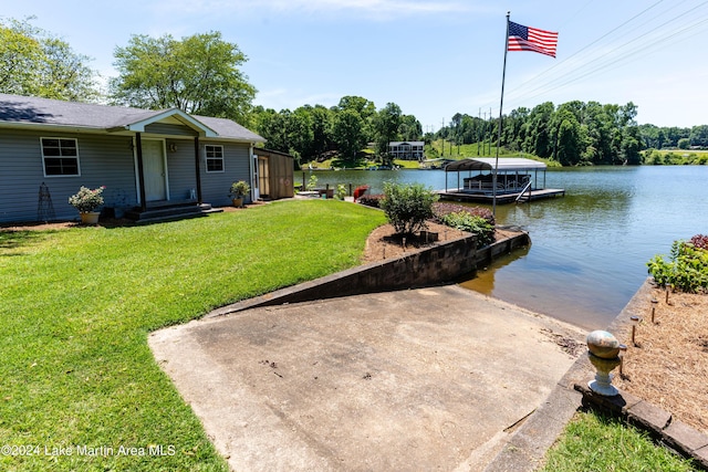 view of yard featuring a dock and a water view