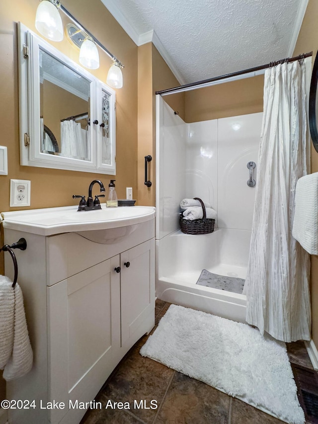 bathroom featuring vanity, curtained shower, ornamental molding, and a textured ceiling