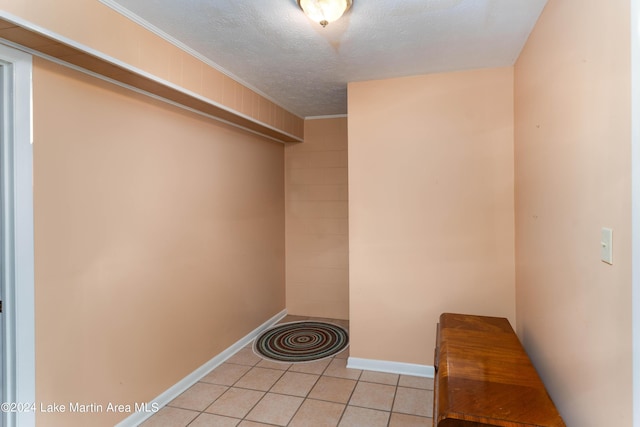 walk in closet with light tile patterned floors