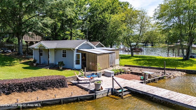 dock area with a yard and a water view